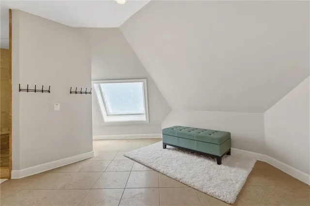a view of a lake with a bench and trees in the background