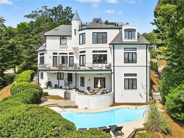 a living room with fireplace furniture and a large window