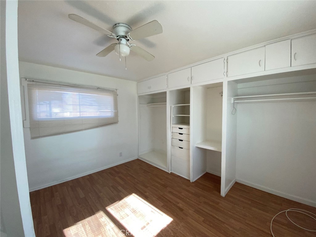 13193 Navajo Road, Unit 3 Apple Valley, CA 92308 - Photo 12 of 17 an empty room with wooden floor closet and windows