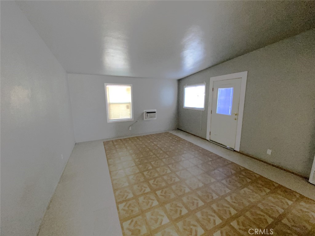 13193 Navajo Road, Unit 3 Apple Valley, CA 92308 - Photo 17 of 17 an empty room with windows and closet in a room