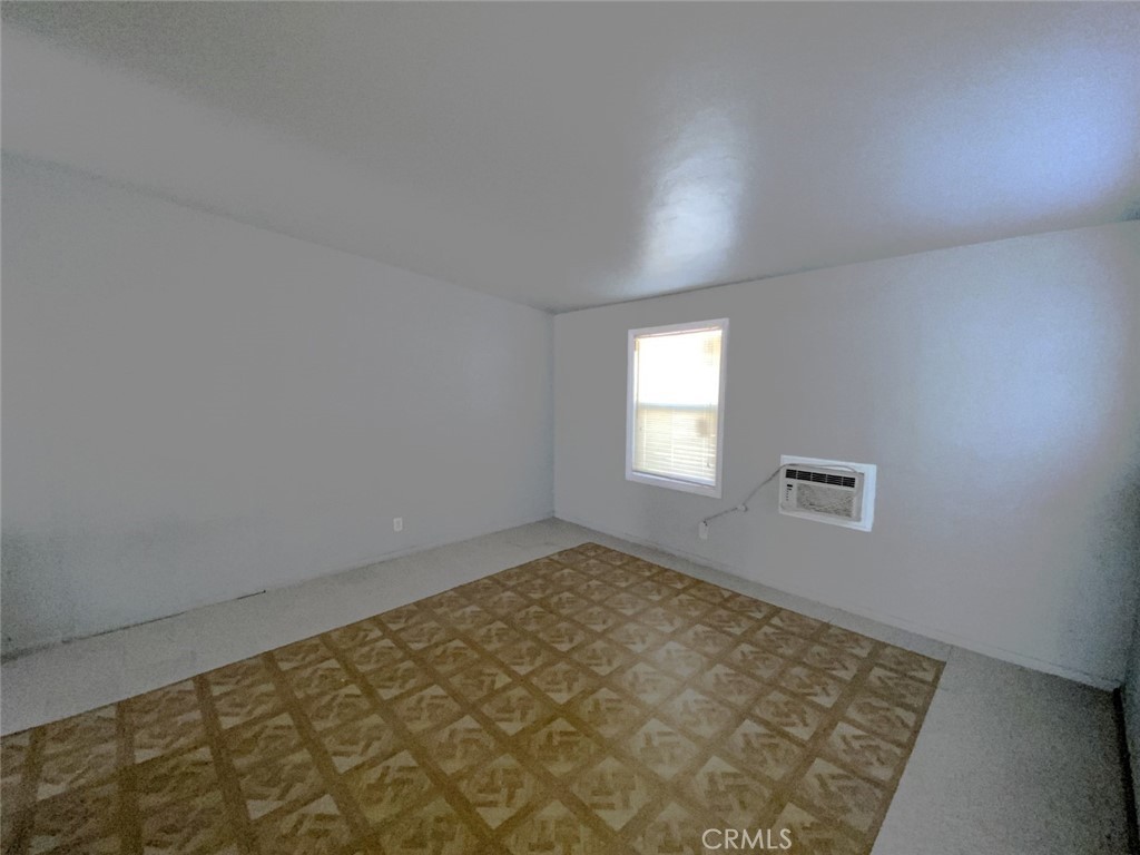 13193 Navajo Road, Unit 3 Apple Valley, CA 92308 - Photo 4 of 17 an empty room with windows