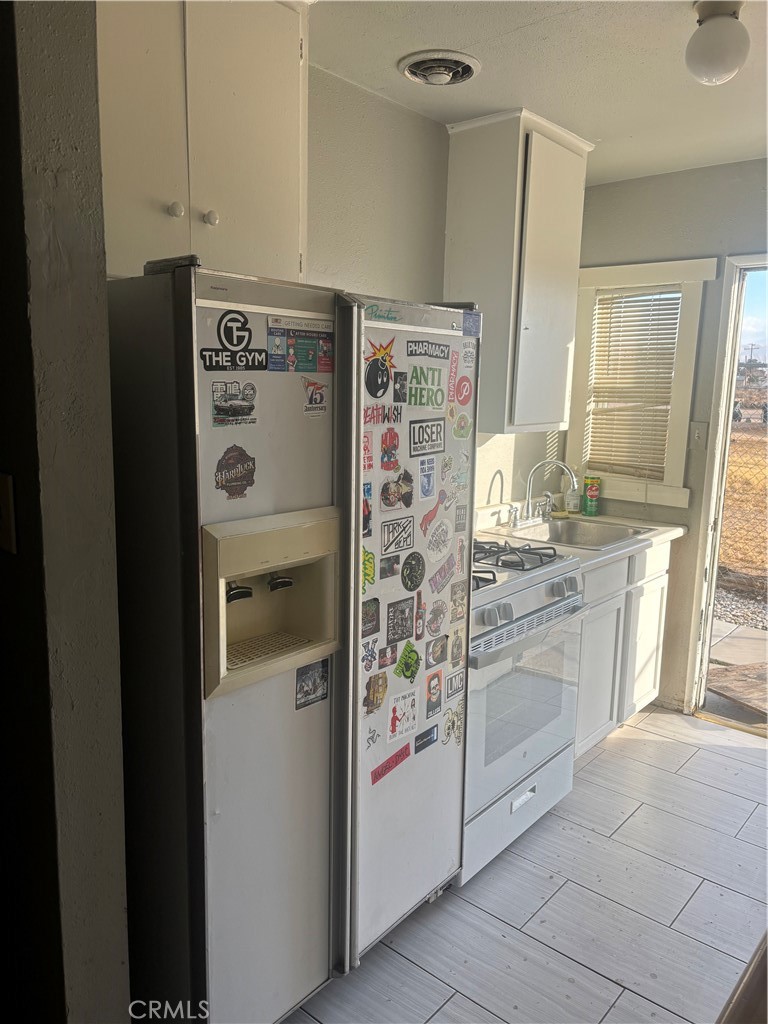 13193 Navajo Road, Unit 3 Apple Valley, CA 92308 - Photo 6 of 17 a kitchen with stainless steel appliances a refrigerator and a stove