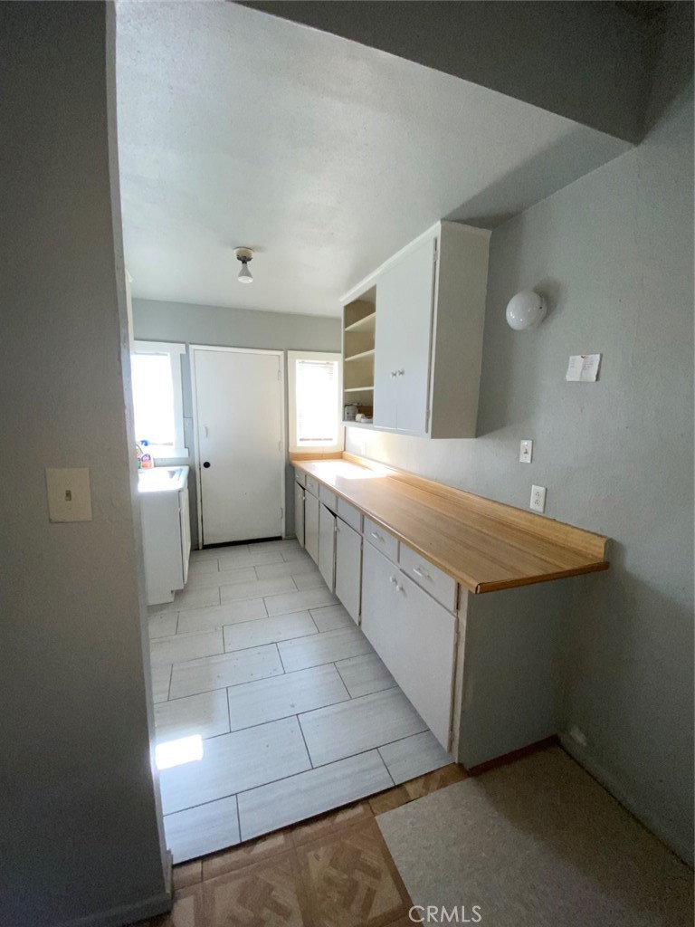 13193 Navajo Road, Unit 3 Apple Valley, CA 92308 - Photo 7 of 17 a bathroom with a sink a toilet and mirror
