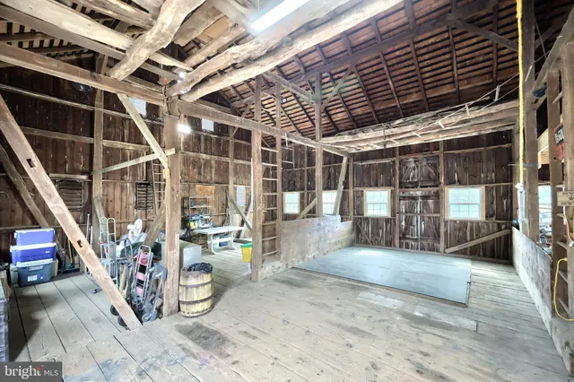 a view of backyard with swimming pool and trees in the background