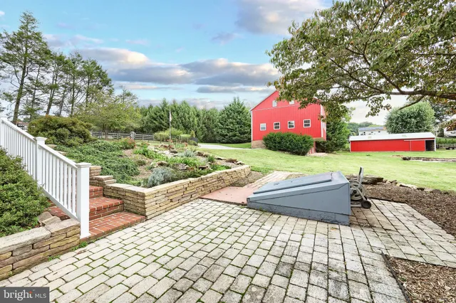 a bathroom with a sink a toilet a mirror and shower