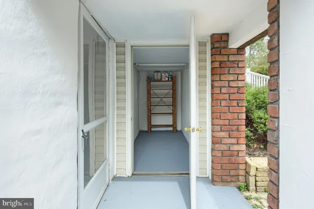 a view of a hallway view with wooden floor and staircase