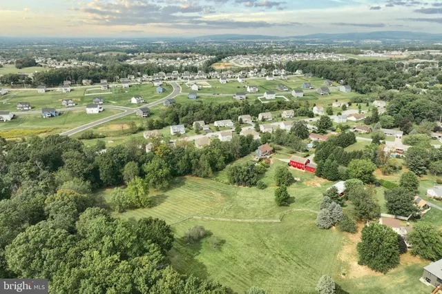 a aerial view of a house with swimming pool and sitting area