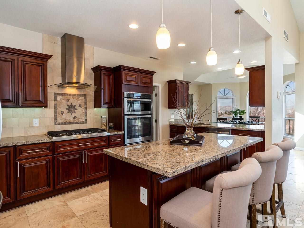 3285 Trumpeter Court Reno, NV 89509 - Photo 11 of 25 a kitchen with stainless steel appliances granite countertop a stove a sink and a refrigerator
