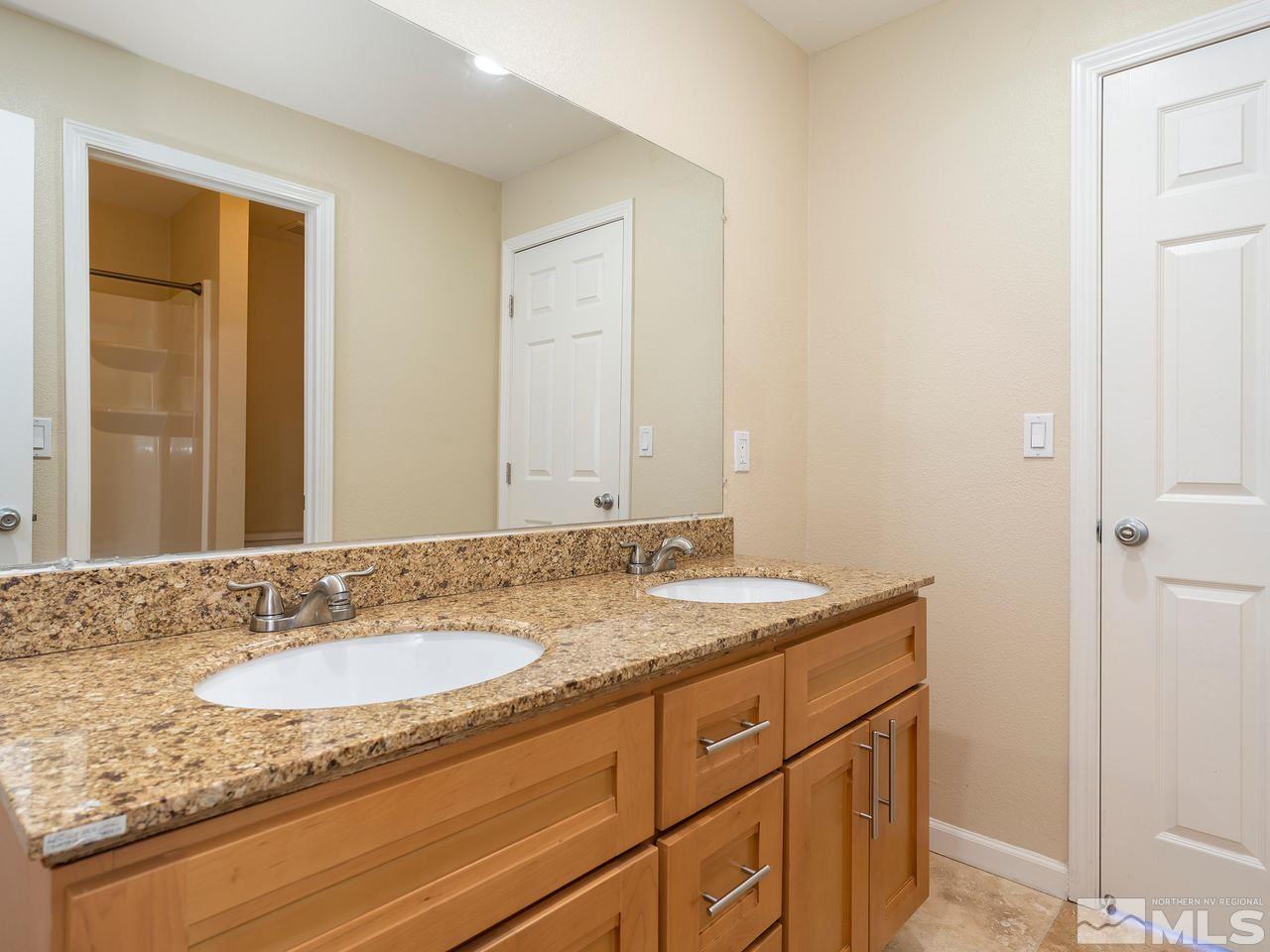 3285 Trumpeter Court Reno, NV 89509 - Photo 21 of 25 a bathroom with a granite countertop sink and a mirror