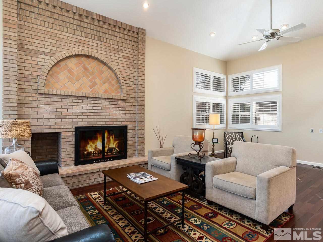 3285 Trumpeter Court Reno, NV 89509 - Photo 8 of 25 a living room with furniture a fireplace a flat screen tv and a fireplace