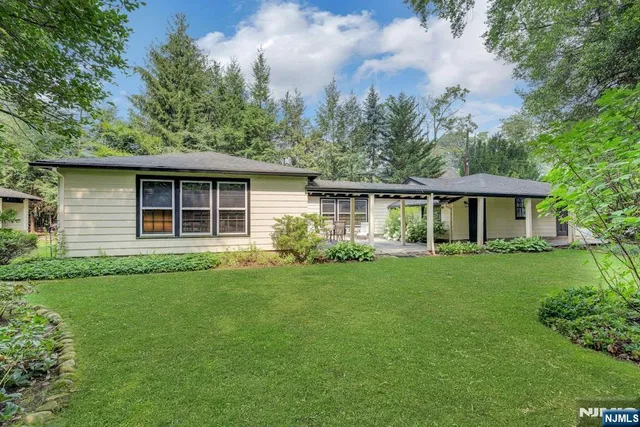 a view of a house with yard and glass windows