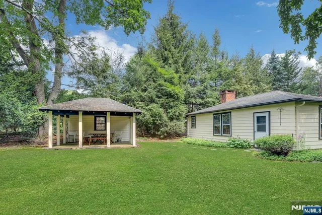 a view of a house with a yard and garage