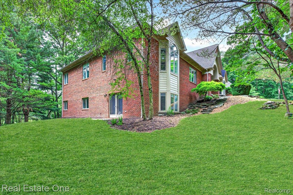 425 Courtney Road Leonard, MI 48367 - Photo 58 of 89 Brick exterior featuring a prominent two-story bay window with vertical siding accents