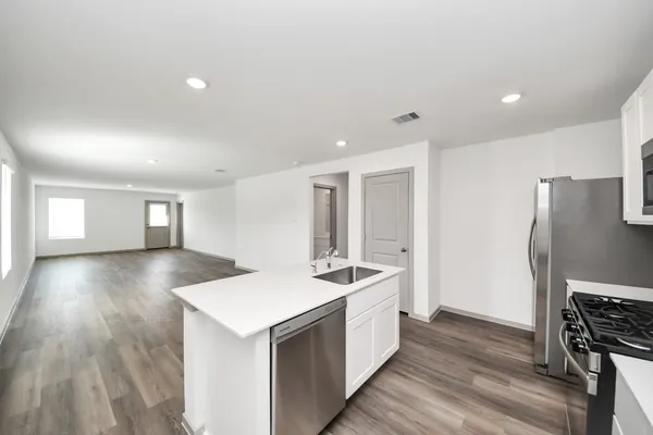 a view of a kitchen cabinets a sink and wooden floor