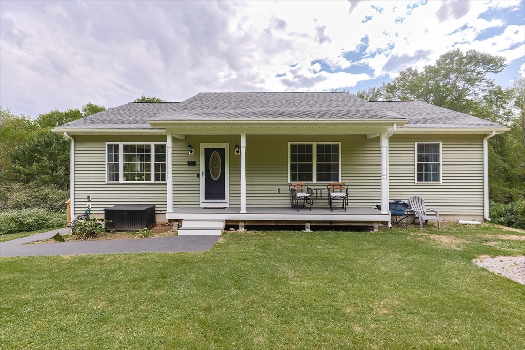 a front view of a house with a garden and patio