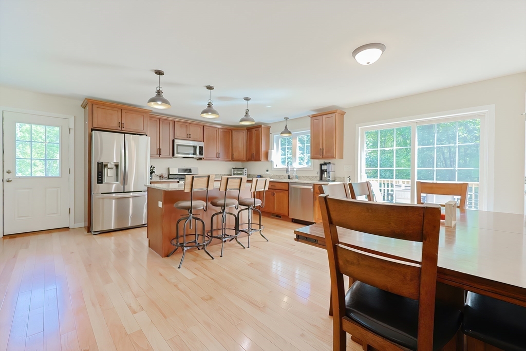 30 Town Farm Road North Brookfield, MA 01535 - Photo 12 of 42 a living room with stainless steel appliances furniture a dining table and a refrigerator