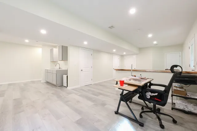a workspace with furniture and white cabinets
