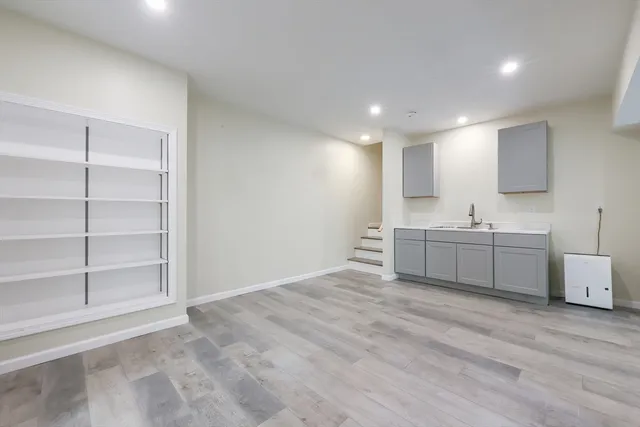 a bathroom with a sink vanity and mirror