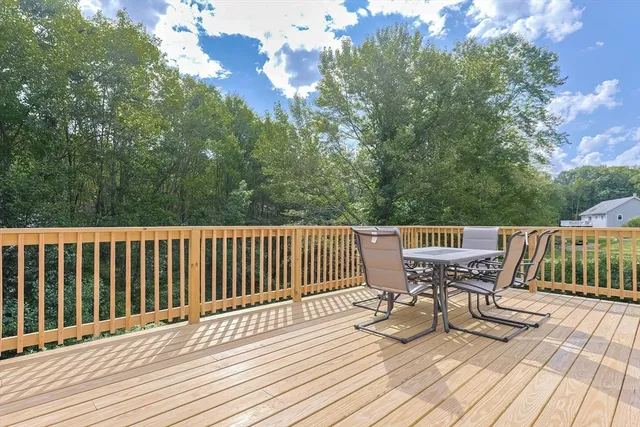 a view of a wooden deck with furniture