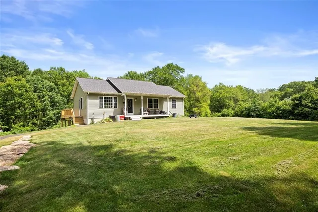 a backyard of a house with table and chairs