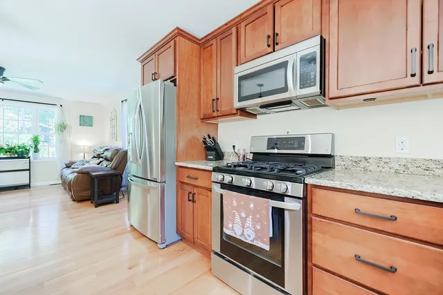 a kitchen with stainless steel appliances granite countertop a stove a microwave and a refrigerator