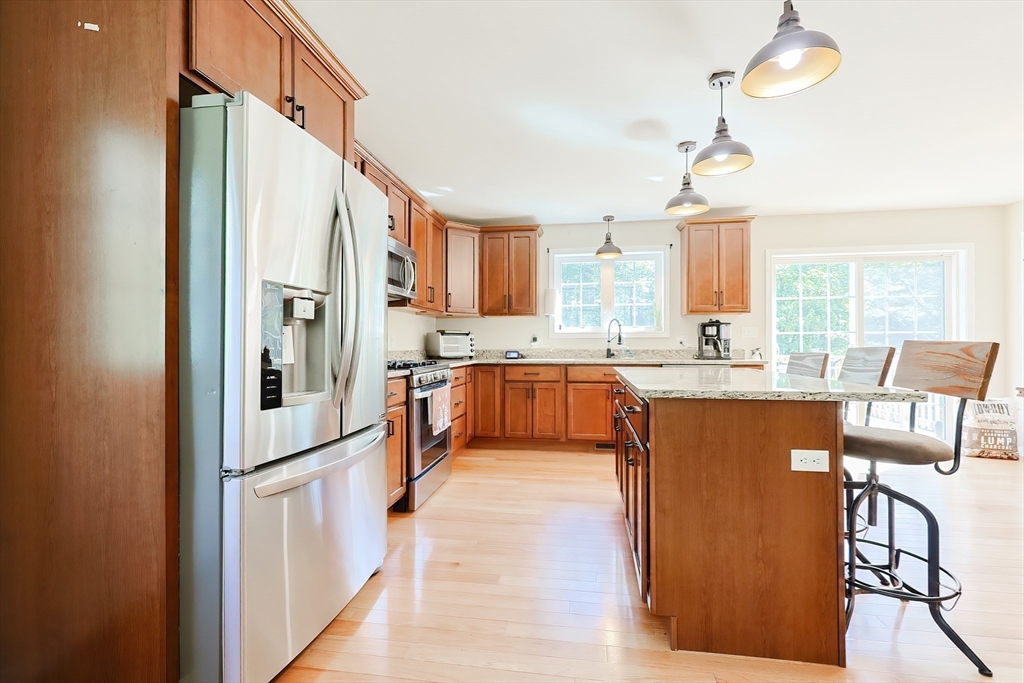 30 Town Farm Road North Brookfield, MA 01535 - Photo 10 of 42 a kitchen with stainless steel appliances granite countertop a refrigerator a oven a sink with island and chairs