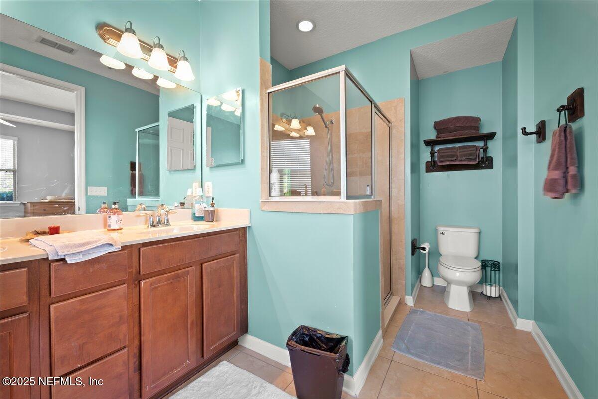 168 Plaza Del Rio Drive St. Augustine, FL 32084 - Photo 21 of 34 a bathroom with a sink a toilet and mirror