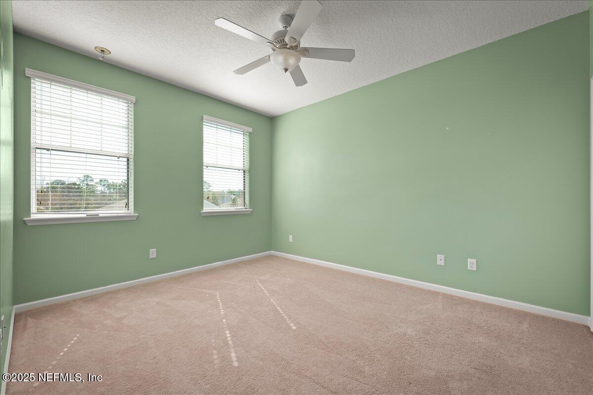 168 Plaza Del Rio Drive St. Augustine, FL 32084 - Photo 23 of 34 an empty room with windows and fan
