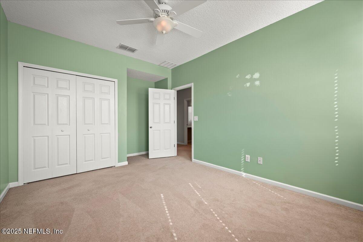 168 Plaza Del Rio Drive St. Augustine, FL 32084 - Photo 24 of 34 an empty room with closet and fan