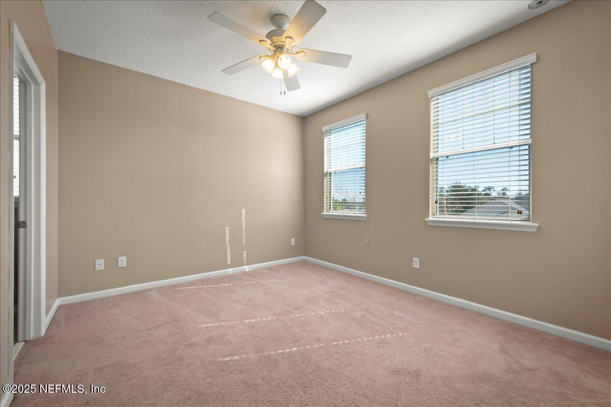 168 Plaza Del Rio Drive St. Augustine, FL 32084 - Photo 25 of 34 an empty room with windows and fan