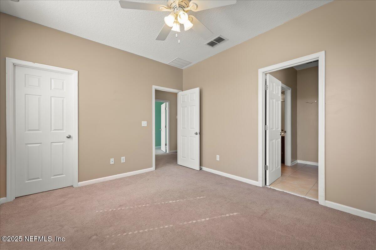 168 Plaza Del Rio Drive St. Augustine, FL 32084 - Photo 26 of 34 a view of an empty room with a chandelier