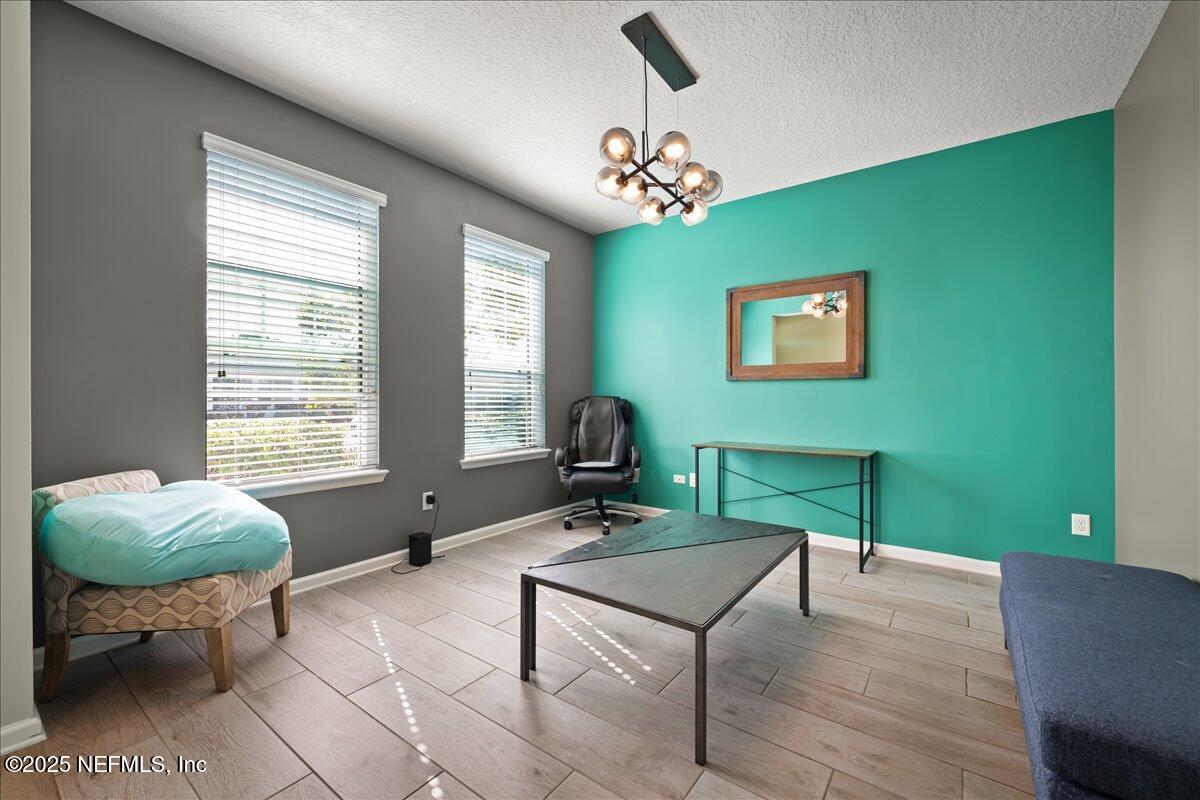 168 Plaza Del Rio Drive St. Augustine, FL 32084 - Photo 5 of 34 a living room with furniture and a chandelier