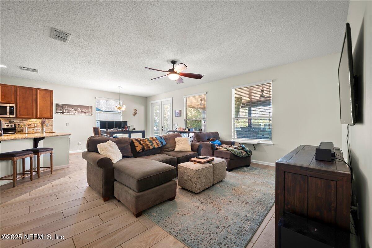 168 Plaza Del Rio Drive St. Augustine, FL 32084 - Photo 6 of 34 a living room with furniture a flat screen tv and a window