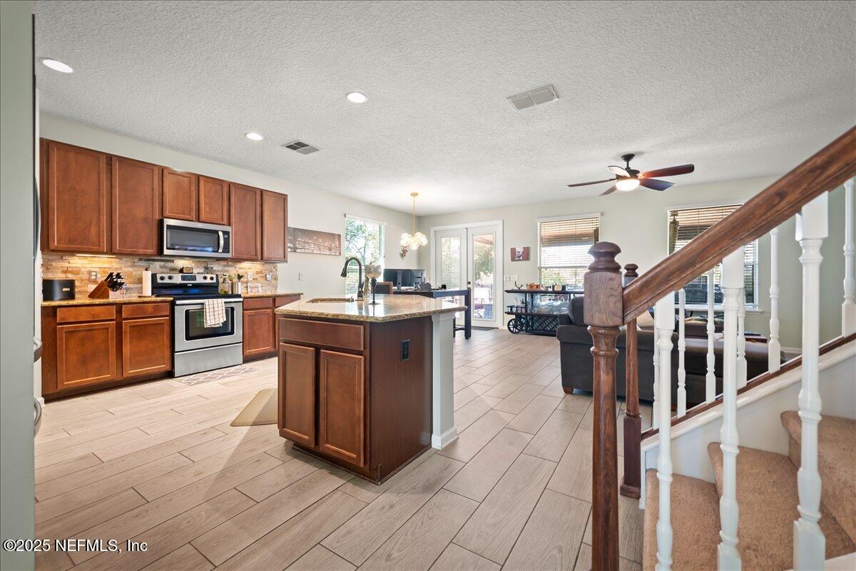 168 Plaza Del Rio Drive St. Augustine, FL 32084 - Photo 8 of 34 a kitchen with stainless steel appliances granite countertop a stove top oven a sink a counter top space and cabinets