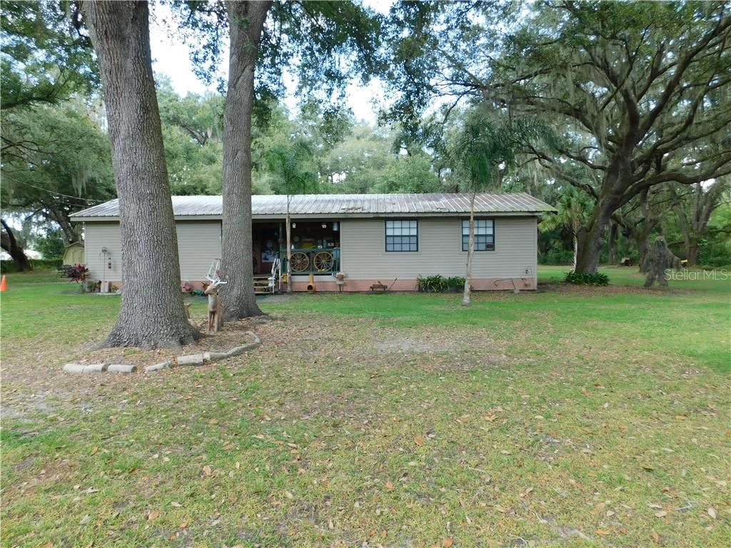 5068 Booth Road Plant City, FL 33565 - Photo 1 of 1 a view of a house with yard and a tree