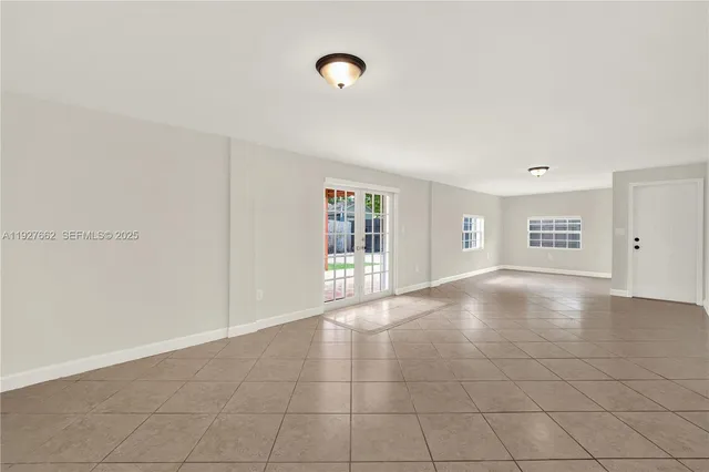 a view of an empty room with glass door