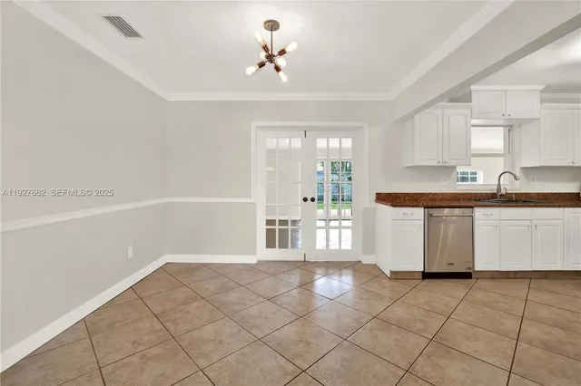 a kitchen with a sink a stove cabinets and a window