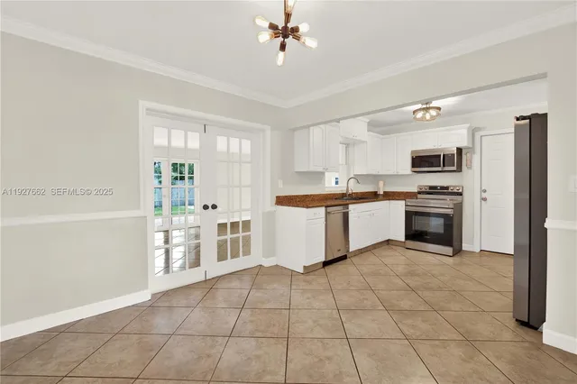 a large kitchen with cabinets and stainless steel appliances