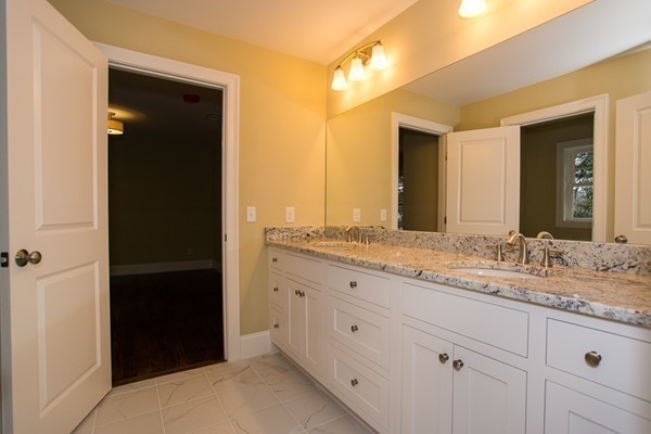 14 Winslow Road Wellesley, MA 02481 - Photo 12 of 18 a bathroom with a granite countertop sink and a mirror