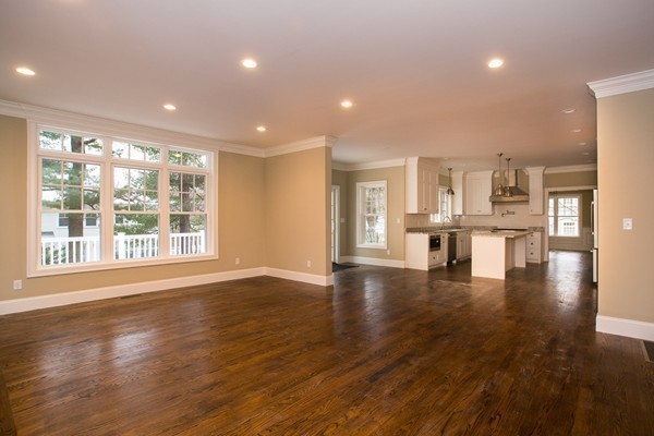 14 Winslow Road Wellesley, MA 02481 - Photo 4 of 18 a view of an empty room with wooden floor and a kitchen