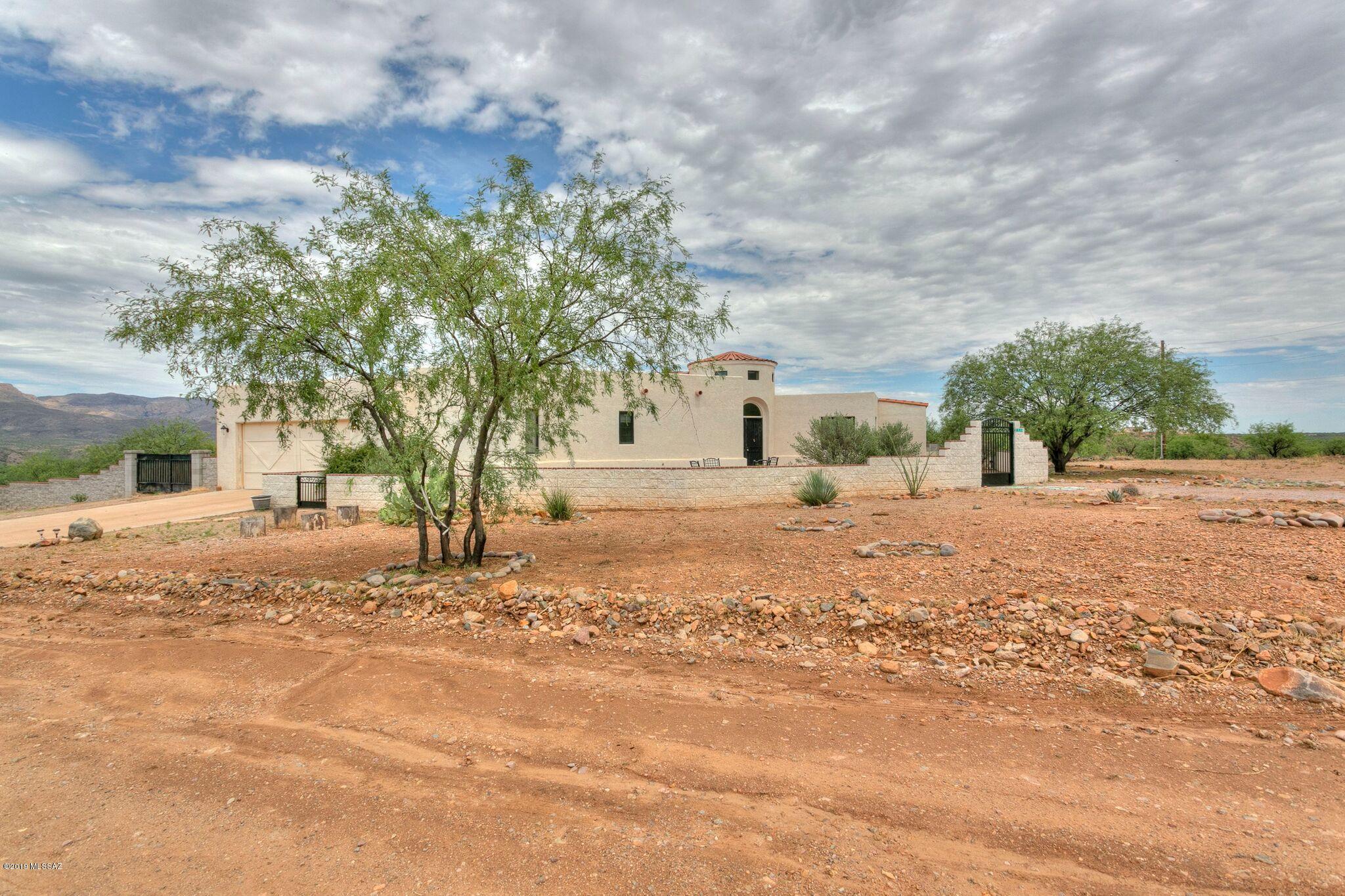 1648 Circulo Puerto Rio Rico, AZ 85648 - Photo 33 of 34 a street view with large trees