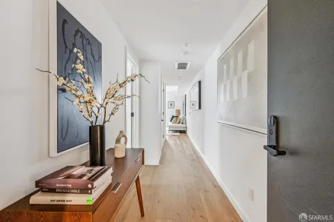 a view of a livingroom with wooden floor and staircase