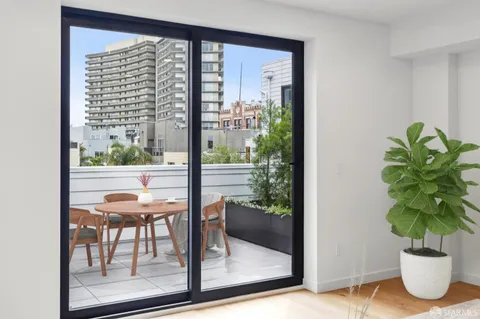 a view of a patio with couches table and chairs and potted plants