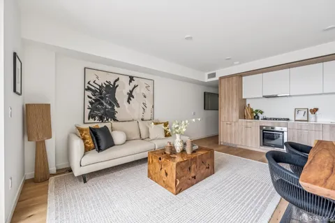 a living room with furniture and a painting