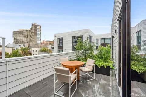 a view of a chair and table in the balcony