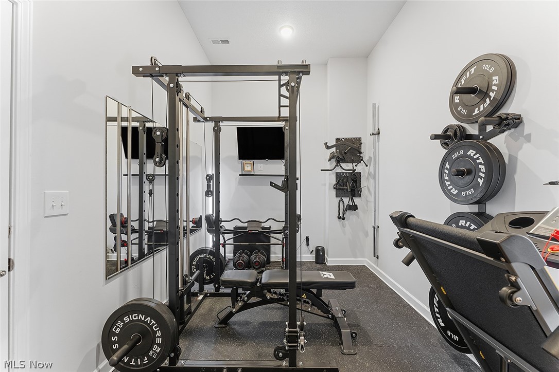 2308 Fulton Road Cleveland, OH 44113 - Photo 27 of 30 Dedicated fitness space featuring rubberized flooring, light gray walls, built-in wall-mounted shelving, and recessed lighting