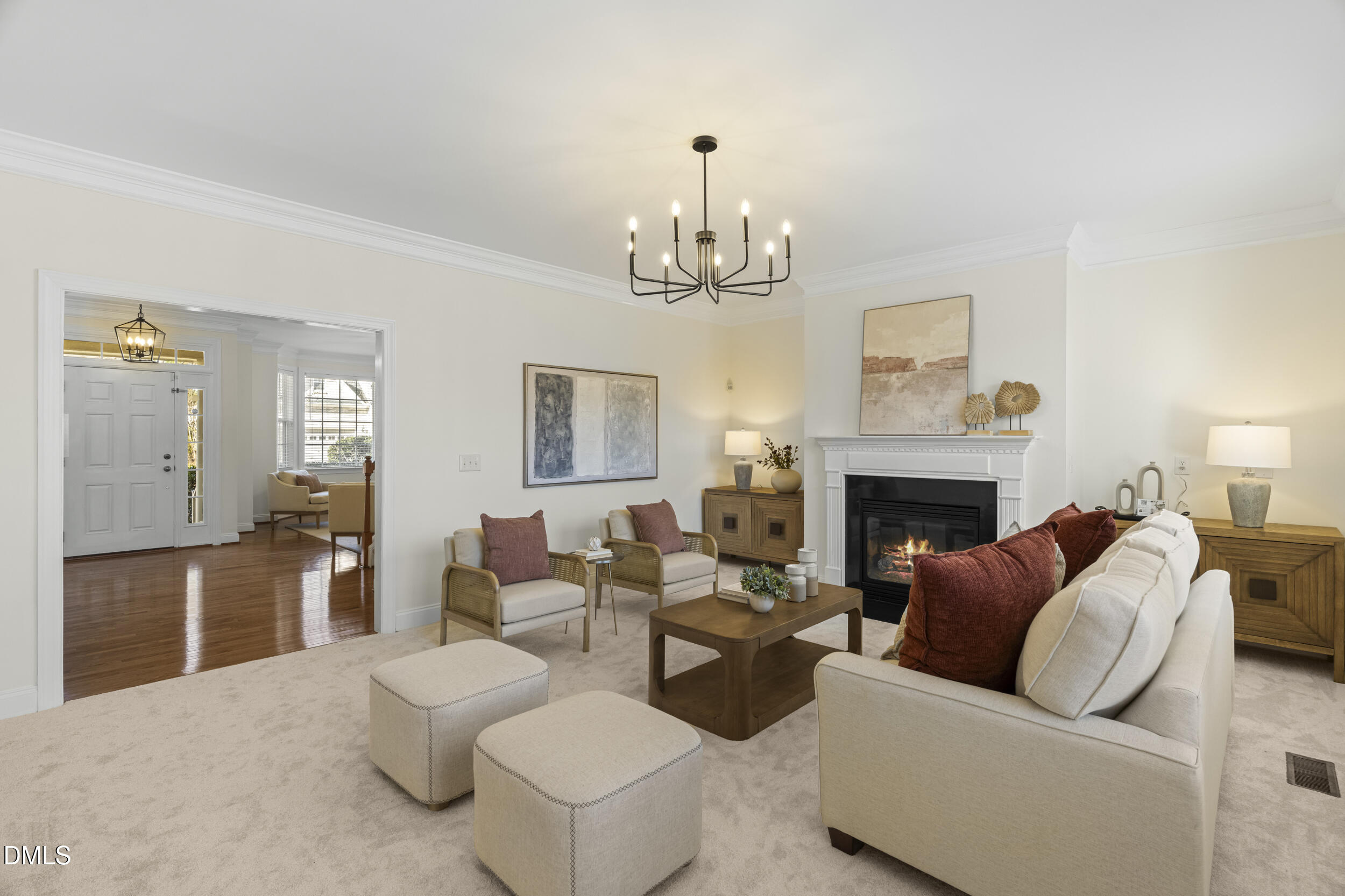 105 Bayless Ridge Court Morrisville, NC 27560 - Photo 17 of 42 a living room with furniture a fireplace and a chandelier