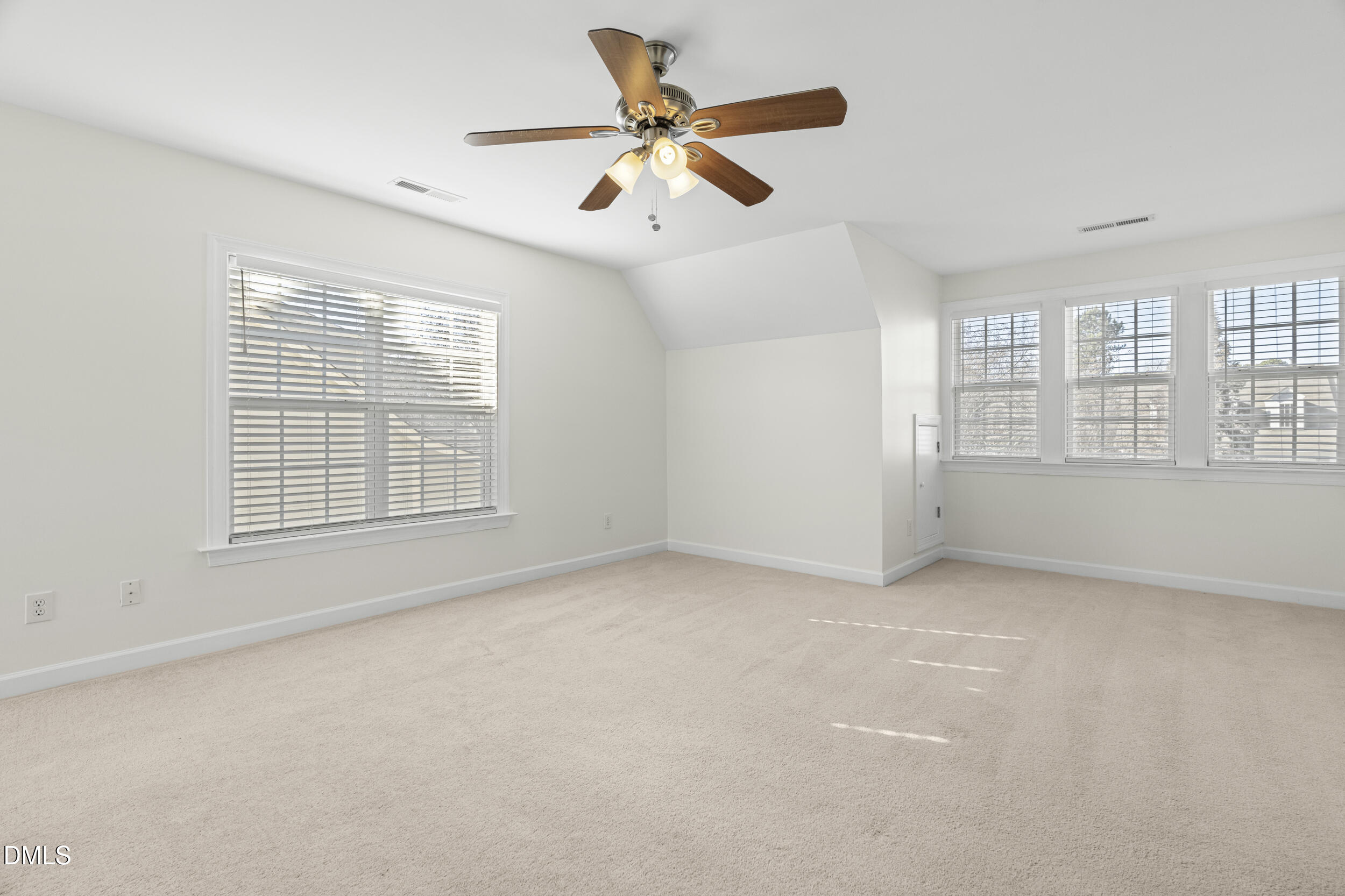 105 Bayless Ridge Court Morrisville, NC 27560 - Photo 22 of 42 an empty room with chandelier fan and windows