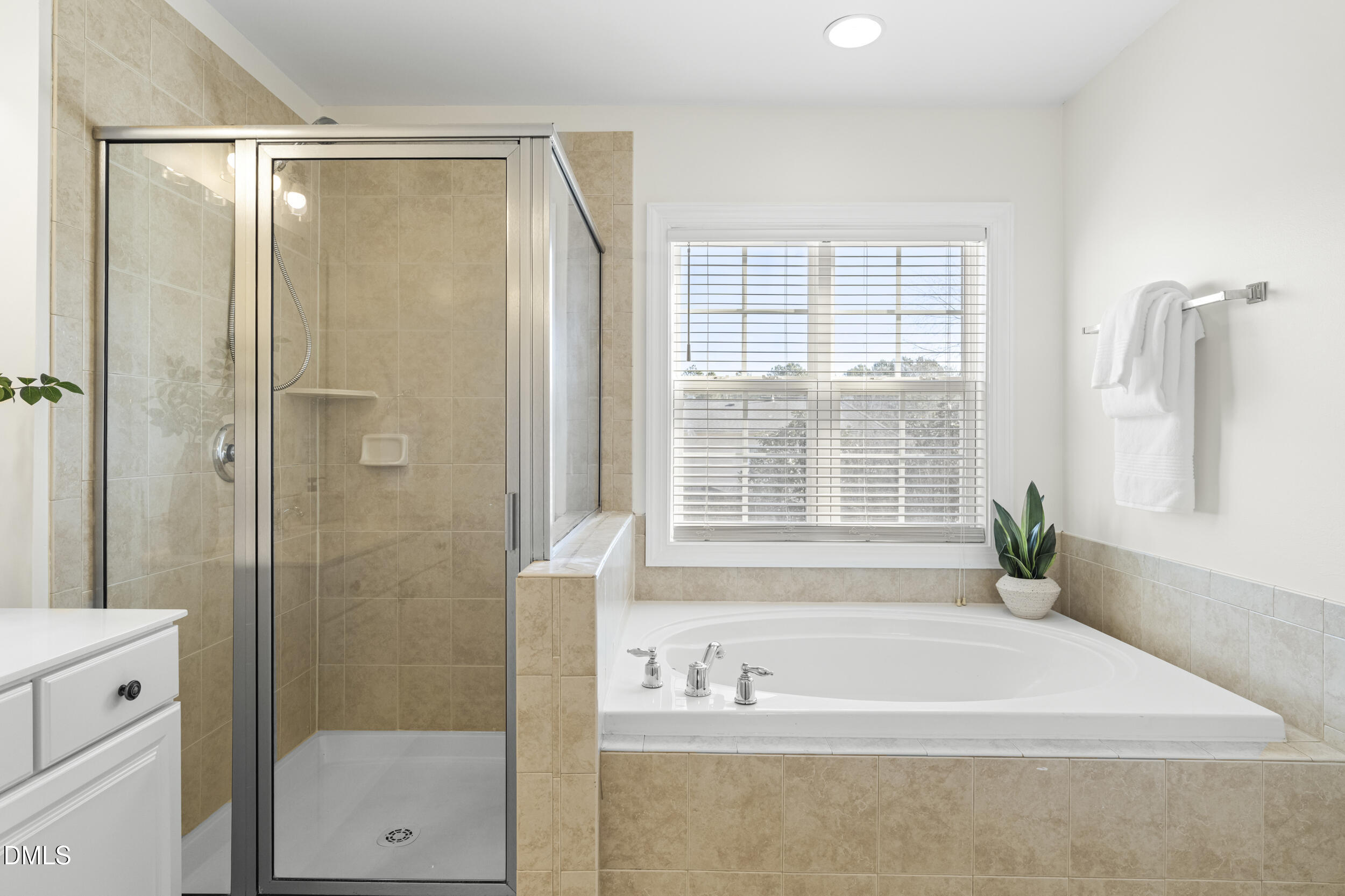 105 Bayless Ridge Court Morrisville, NC 27560 - Photo 28 of 42 a bathroom with a bathtub and a shower