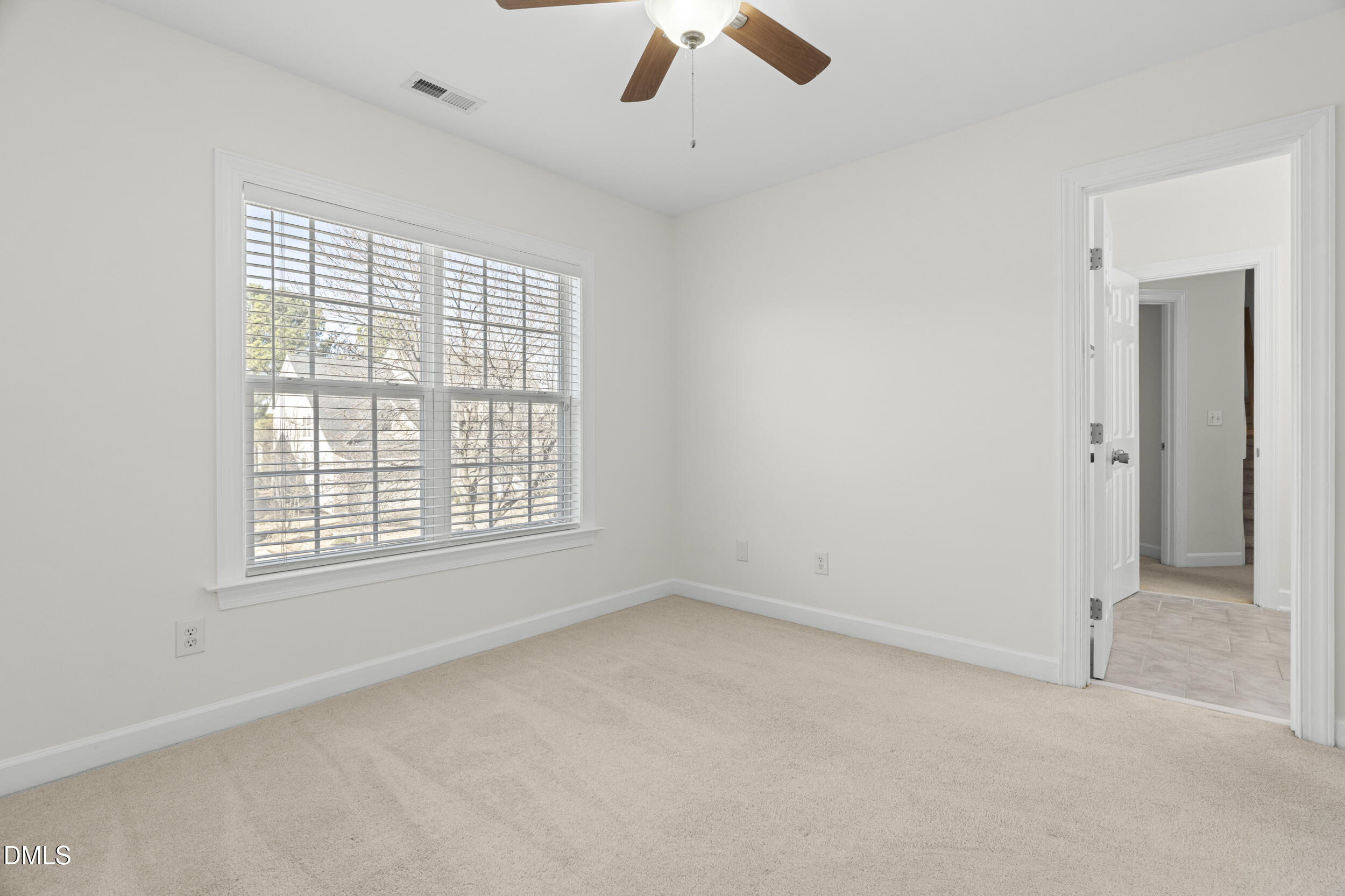 105 Bayless Ridge Court Morrisville, NC 27560 - Photo 33 of 43 an empty room with a window and a ceiling fan